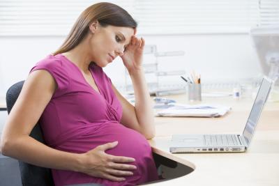 pregnant woman sitting at desk